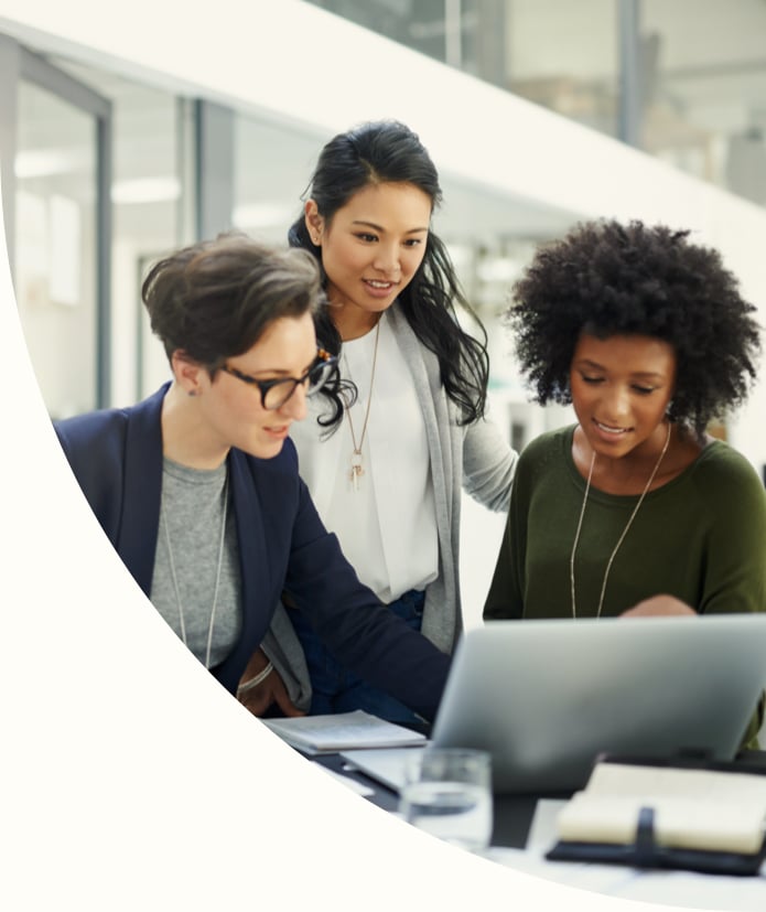 Shot of a group of businesswomen looking at a laptop during a meeting at work