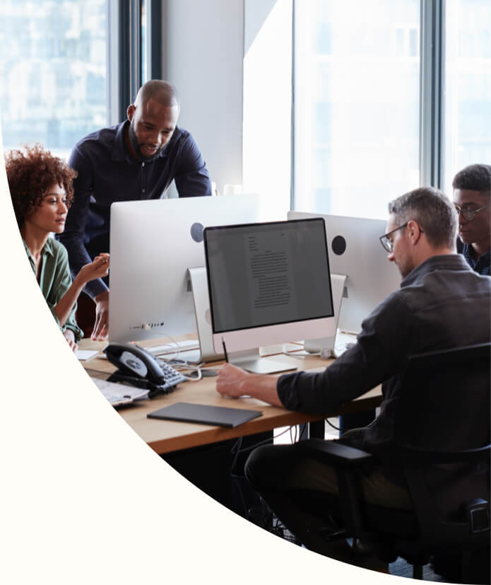 business professionals working together at computers in an office