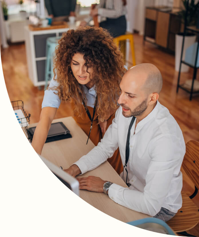 Shot of a women and a man working together on computer