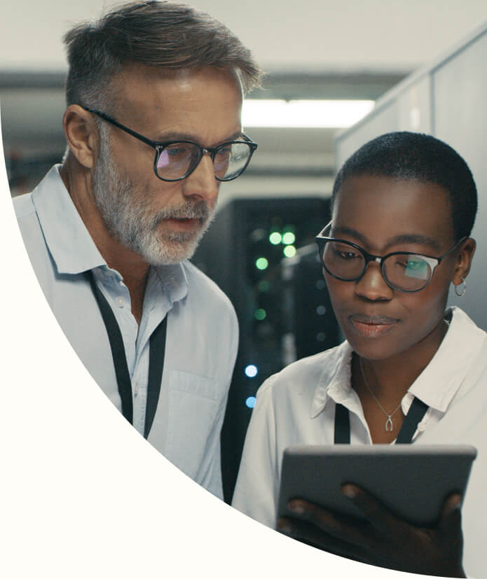 Shot of a man and woman using a digital tablet while working near data servers